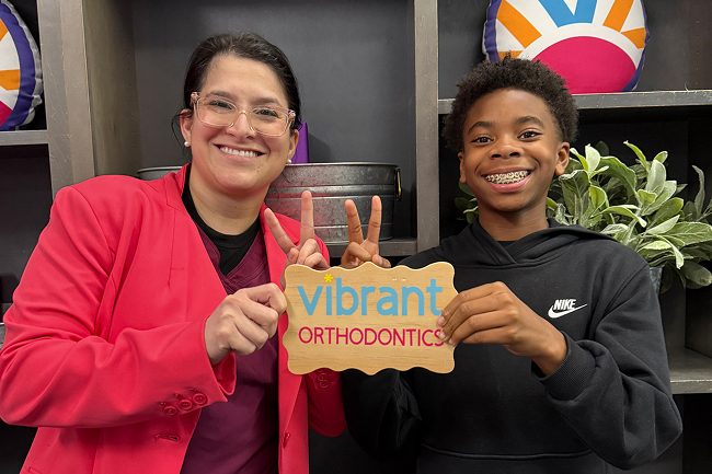Dr. Maryam Rezaie smiling with a child with braces at Vibrant Orthodontics