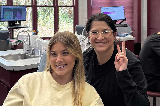 Teen patient with braces and an orthodontic assistant at Vibrant Orthodontics in Tallahassee, FL